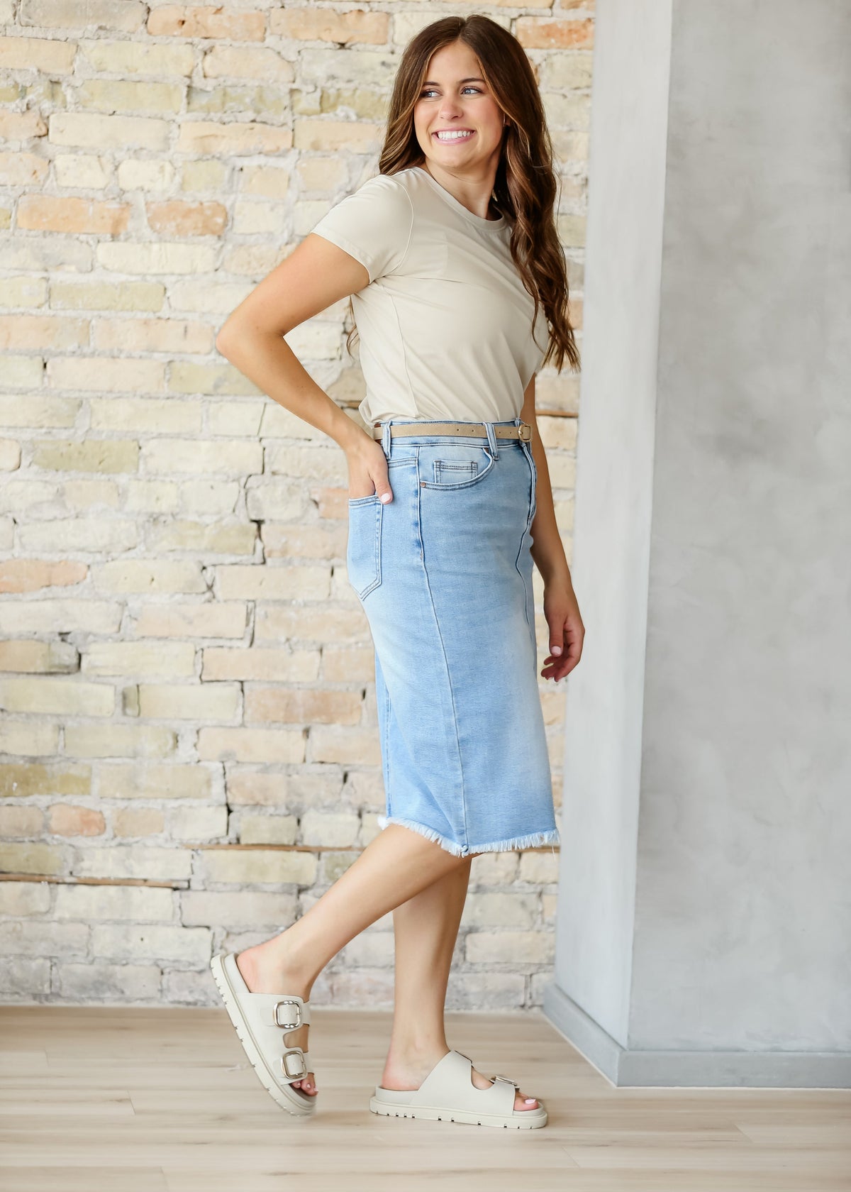 Inherit Co. Drew Raw Hem Midi Denim Skirt showing a classic blue denim fabric with a raw hem detail and midi length.
