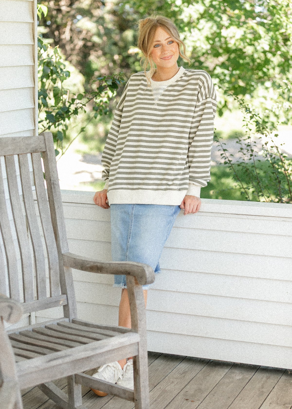 Inherit Co. Drew Raw Hem Midi Denim Skirt featuring a classic denim fabric and raw hem detail, styled with a high waist.