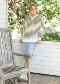 Inherit Co. Drew Raw Hem Midi Denim Skirt featuring a classic denim fabric and raw hem detail, styled with a high waist.