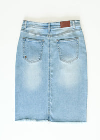 Inherit Co. Drew Raw Hem Midi Denim Skirt with front pockets and faded blue wash, displayed on a plain background.