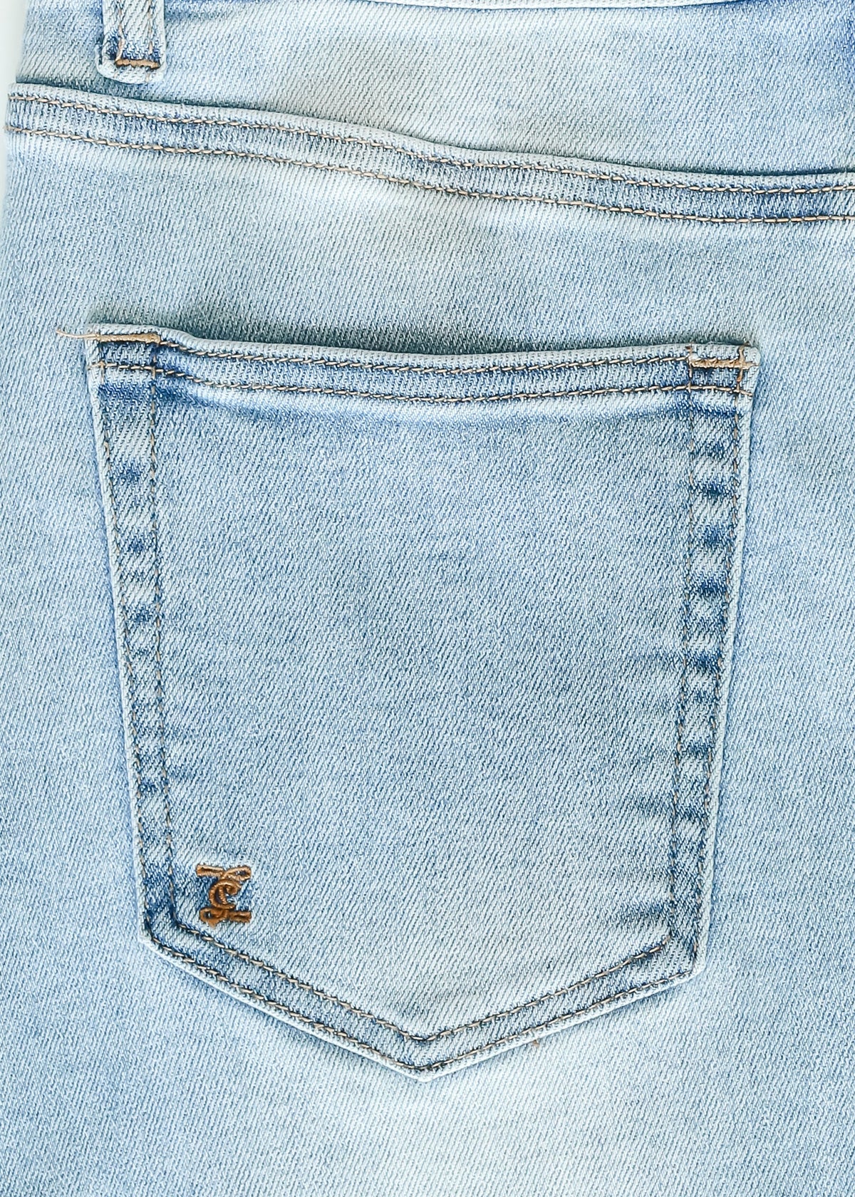 Inherit Co. Drew Raw Hem Midi Denim Skirt with a casual, distressed hem, showcased on a model styled for everyday wear.