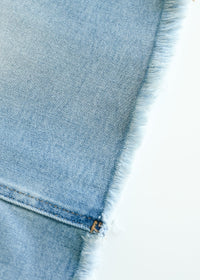 Inherit Co. Drew Raw Hem Midi Denim Skirt with side pockets, showcasing classic blue denim and a raw hem detail.