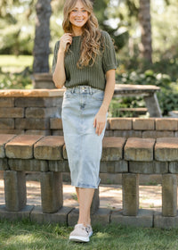 Light wash midi denim skirt by Inherit Co. featuring a classic fit and stylish design, perfect for casual or chic outfits.