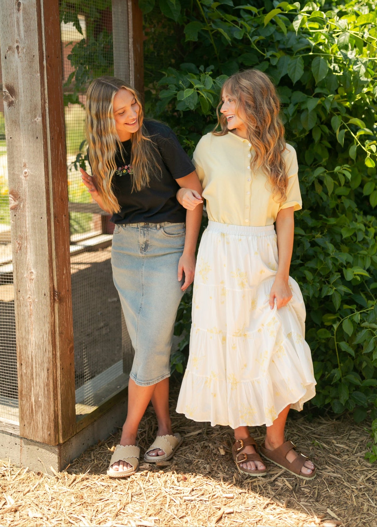 Light wash midi denim skirt from Inherit Co. featuring classic five-pocket style and a flattering A-line silhouette.
