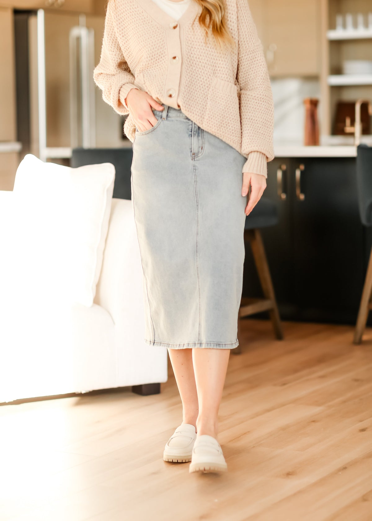 Light wash midi denim skirt by Inherit Co., featuring a classic IC Skirts style with a fitted waist and flowing midi length.