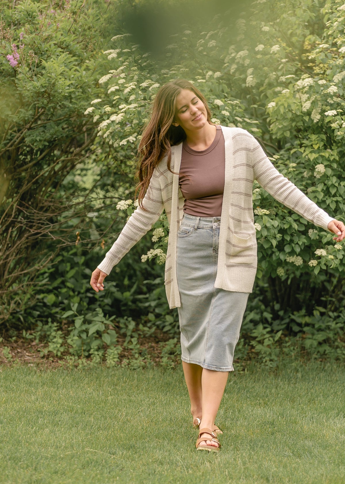 Light wash midi denim skirt by Inherit Co. featuring a classic A-line shape and stylish stitching details.