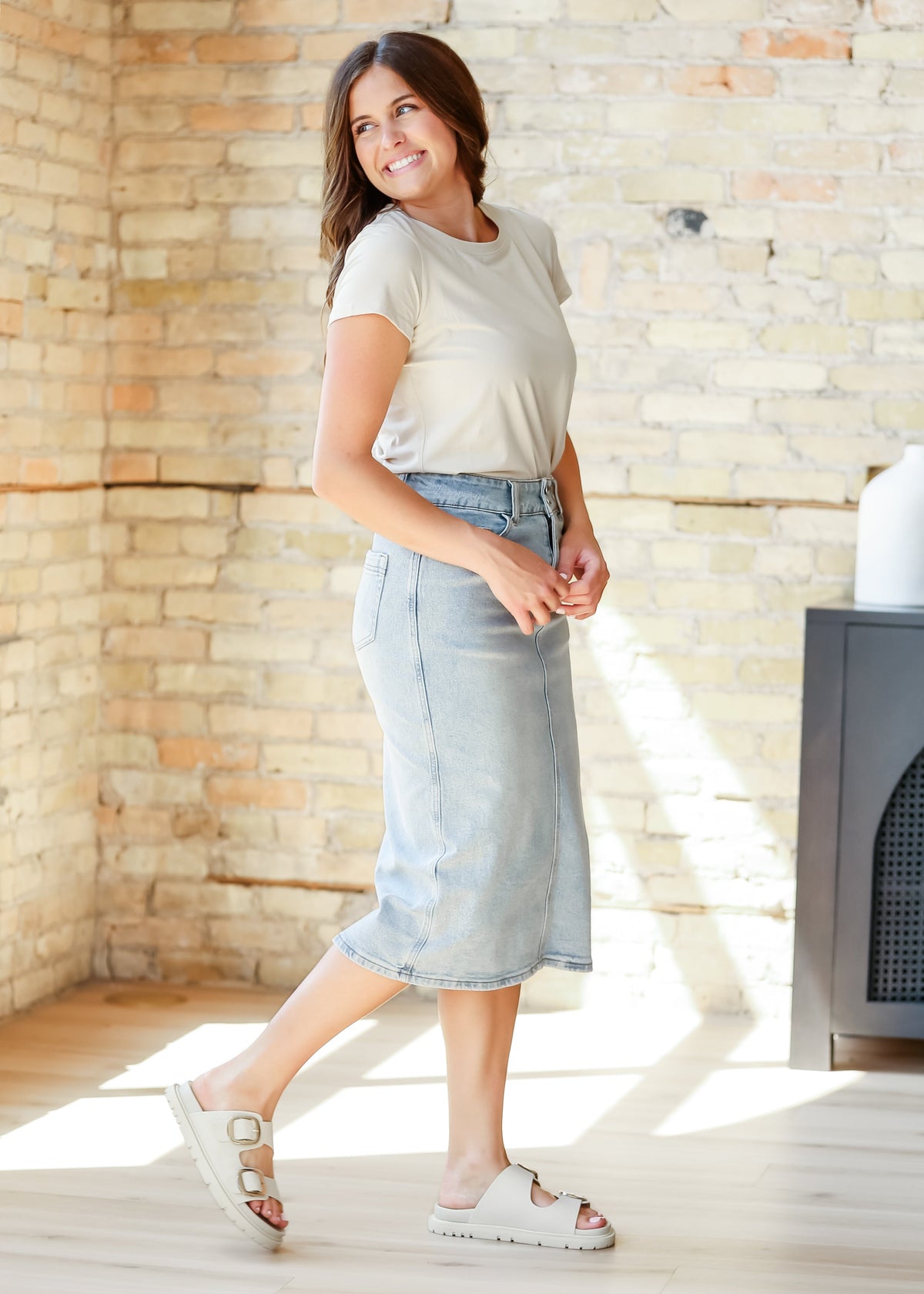 Light wash midi denim skirt by Inherit Co., featuring a classic fit and stylish length, perfect for casual or chic outfits.