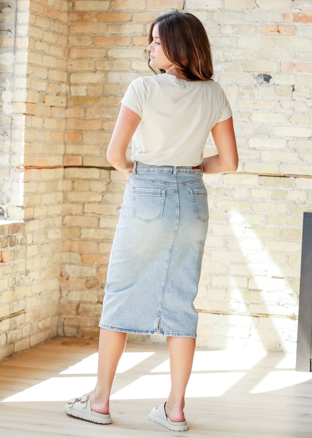 Inherit Co. Greta light wash midi denim skirt from IC Skirts collection, styled with casual top and shoes.