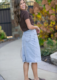 Inherit Co. Sandra light wash denim midi skirt from IC Skirts, showcasing a classic A-line style with front pockets and belt loops.