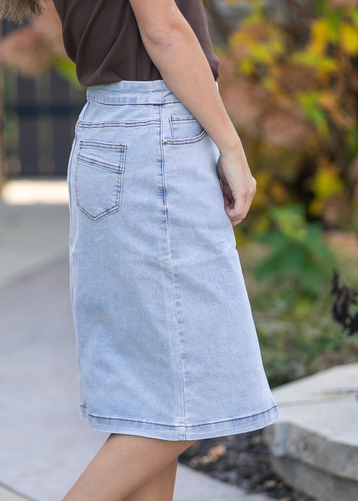Inherit Co. Sandra light wash denim midi skirt from IC Skirts, showing a high-waisted, knee-length denim skirt with a casual fit.