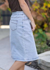 Inherit Co. Sandra light wash denim midi skirt from IC Skirts, showing a high-waisted, knee-length denim skirt with a casual fit.