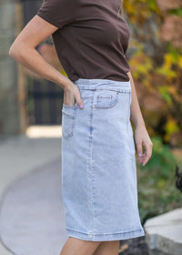 Inherit Co. Sandra light wash denim midi skirt, casual style with a flattering fit, shown on a model against a neutral background.