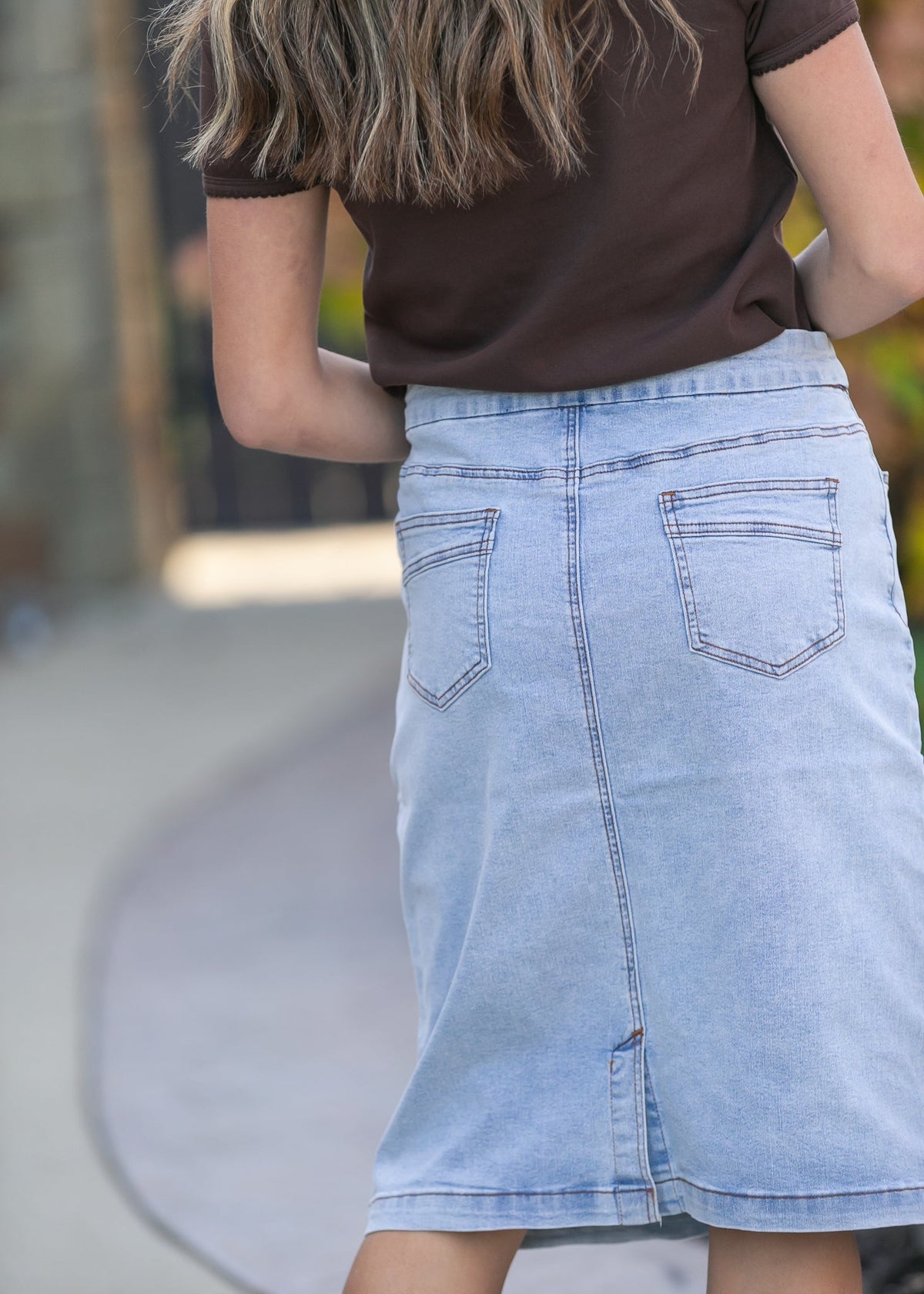 Inherit Co. Sandra Light Wash Denim Midi Skirt from IC Skirts, featuring a classic denim design and midi length.