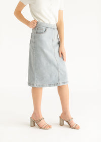 Inherit Co. Sandra light wash denim midi skirt with a classic A-line silhouette, displayed on a neutral background.