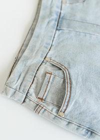 Inherit Co. Sandra light wash denim midi skirt, stylish IC Skirt featuring a classic A-line silhouette and front pockets.