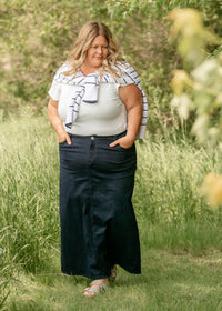 Inherit Co. Stella navy maxi denim skirt, flowing and stylish with a high waist and full-length design, displayed on a hanger.