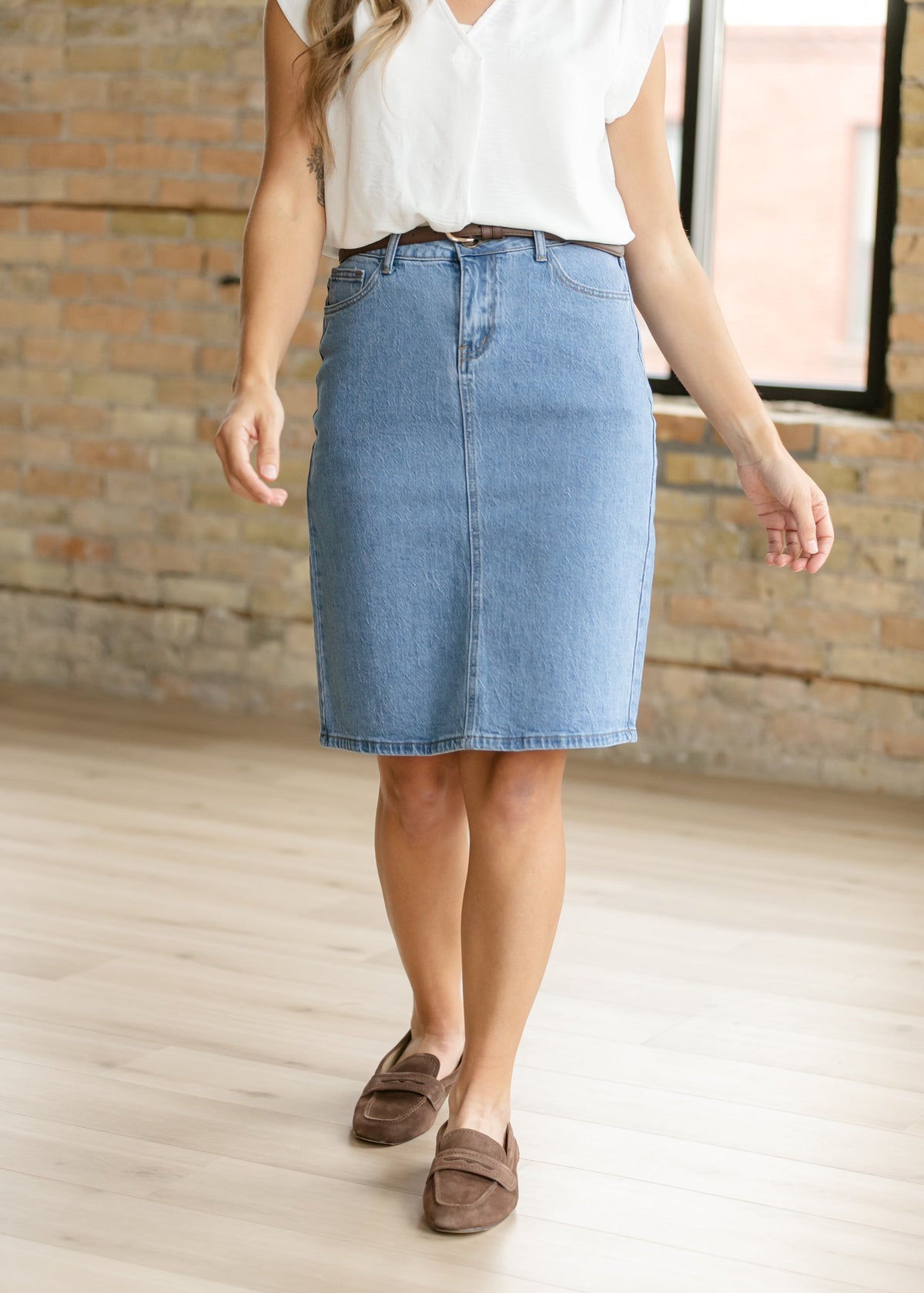 Inherit Co. Remi Denim Classic Wash Midi Skirt with a high waist and A-line silhouette, displayed on a hanger.