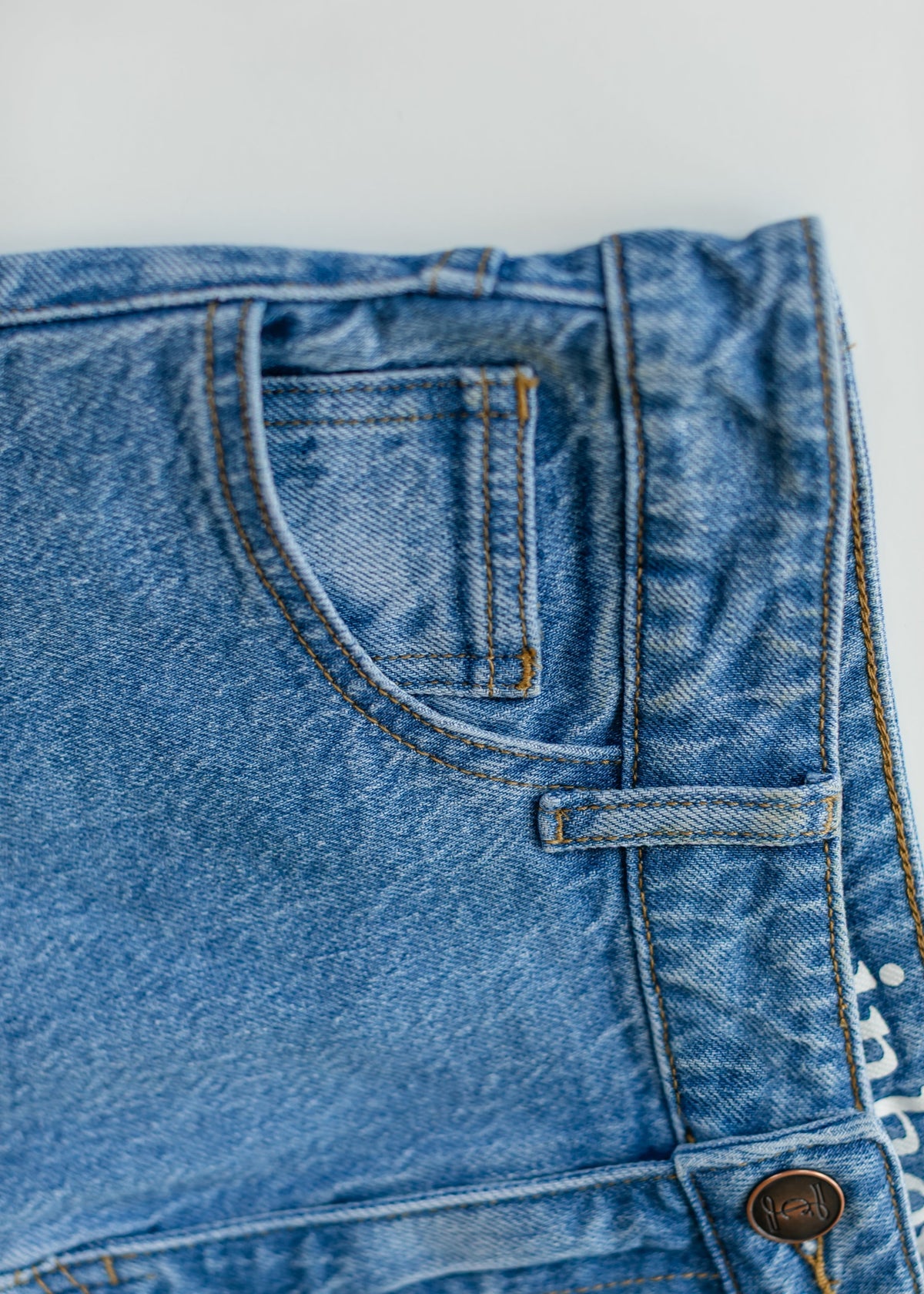 Inherit Co. Remi Denim Classic Wash Midi Skirt featuring a fitted waist and A-line silhouette in soft blue denim.