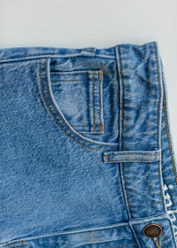 Inherit Co. Remi Denim Classic Wash Midi Skirt featuring a fitted waist and A-line silhouette in soft blue denim.