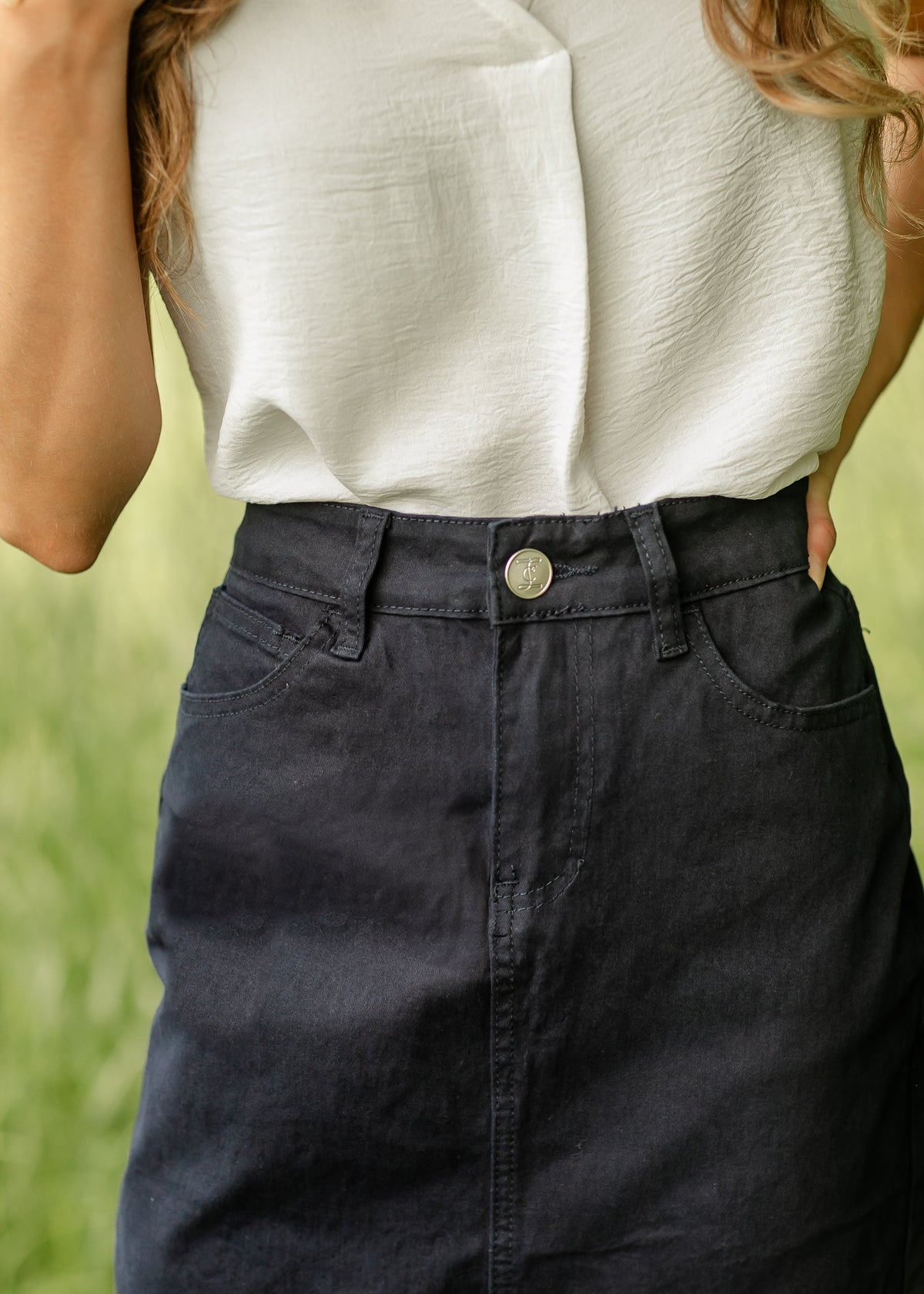 Navy denim midi skirt by Inherit Co. from IC Skirts collection, shown with a flowy, mid-length design and classic denim texture.