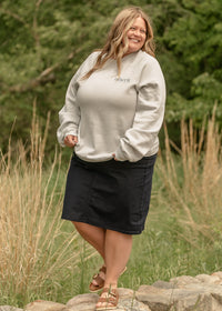 Navy denim midi skirt from Inherit Co. featuring a classic A-line silhouette and front pockets, styled casually.