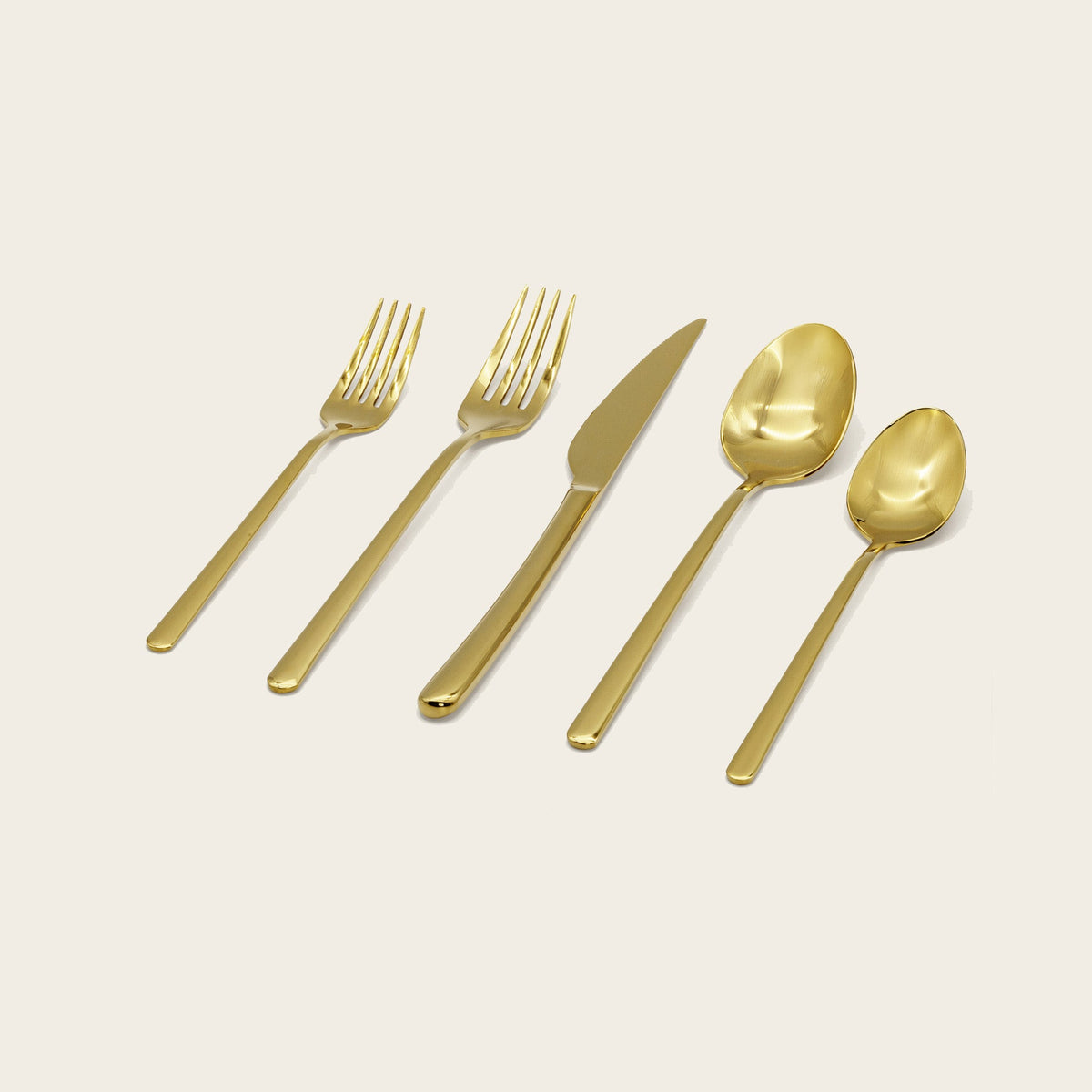 Italic Emilia Mirror 20-Piece Gold Flatware Set featuring elegant knives, forks, and spoons with a polished finish.