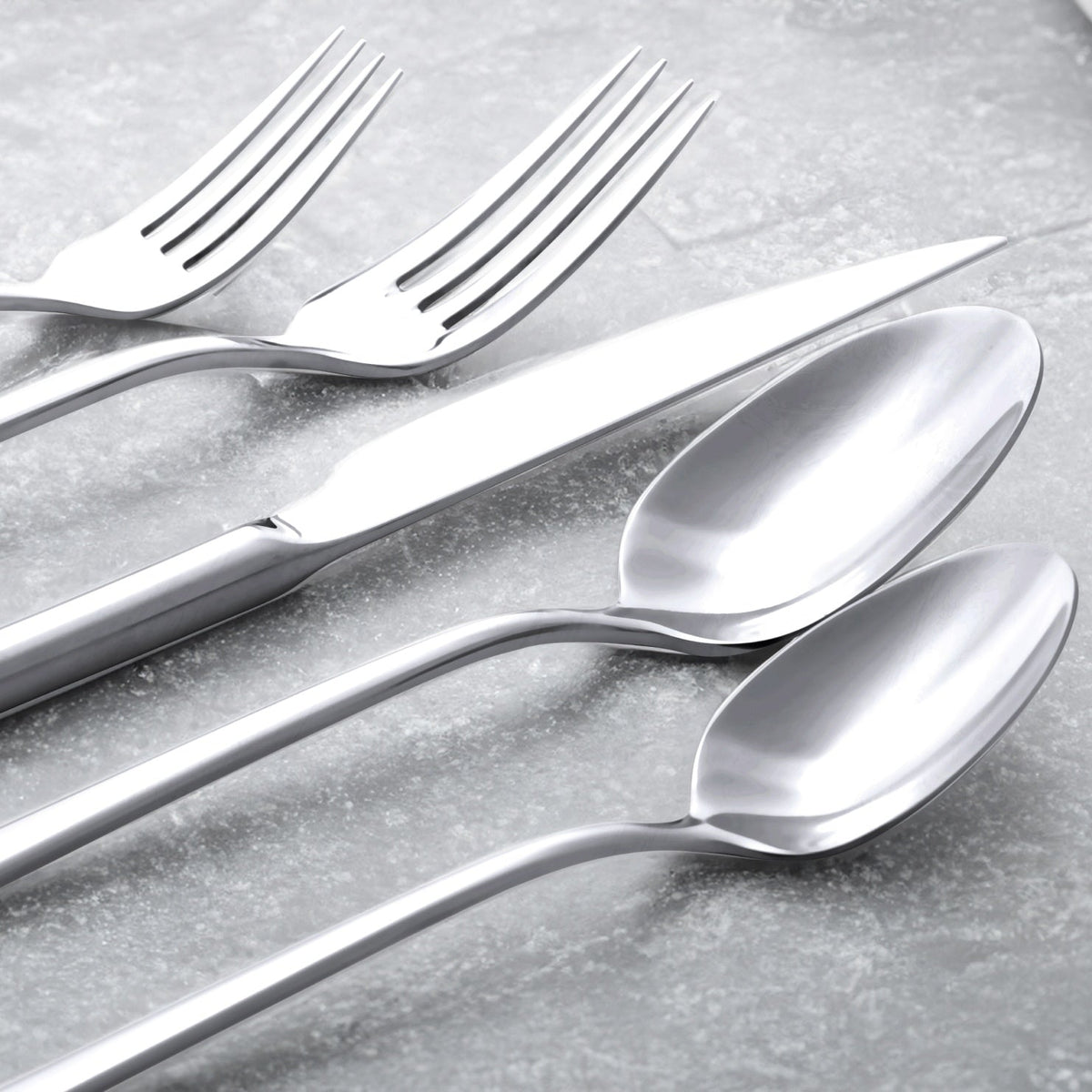 Italic Emilia mirror 20-piece flatware set featuring gold finish, including forks, knives, spoons, and serving pieces arranged on a white background.