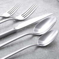 Italic Emilia mirror 20-piece flatware set featuring gold finish, including forks, knives, spoons, and serving pieces arranged on a white background.