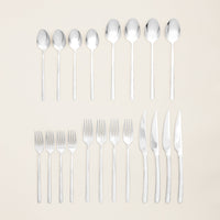 Italic Emilia Mirror 20-piece flatware set featuring gold stainless steel forks, knives, spoons, and teaspoons arranged neatly.