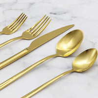 Italic Emilia Mirror 20-piece flatware set with gold finish, featuring forks, knives, spoons, and serving pieces on a white background.