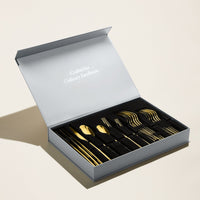 Italic Emilia Mirror 20-piece flatware set featuring gold finish and sleek design, including forks, knives, spoons, and serving utensils.