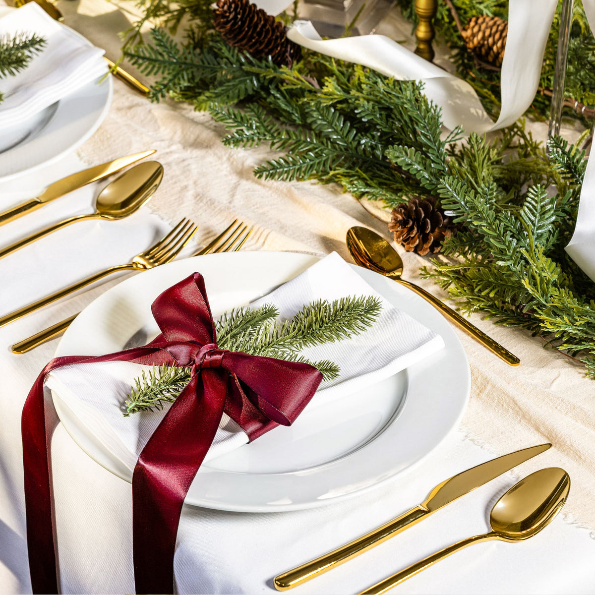Italic Emilia Mirror 20-piece gold flatware set with sleek handles and polished finish, including forks, knives, spoons, and teaspoons.