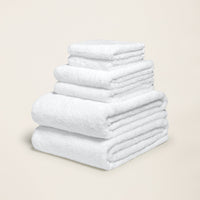 Set of two Italic Ultraplush Australian Cotton Bath Towels, soft and plush for home use, displayed on a bathroom countertop.