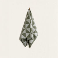Set of two Italic Umbra bath towels in sage and ecru, soft and plush for home use, shown with one washcloth in matching colors.