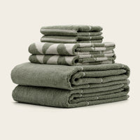 Set of two Italic Umbra bath towels in sage and ecru with a soft, plush texture for home bath use.
