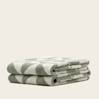 Set of two Italic Umbra bath washcloths in sage and ecru, soft home towel collection for everyday use.
