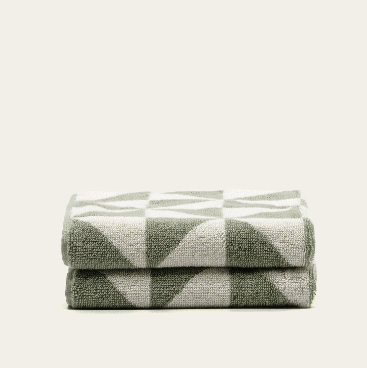 Set of two Italic Umbra bath towels in sage and ecru, soft and plush for home use.