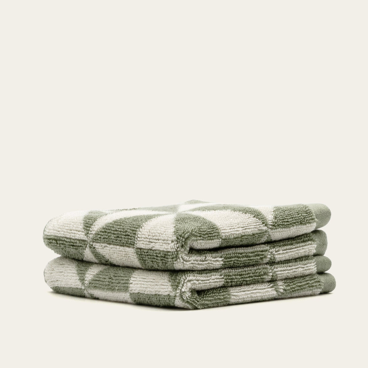 Set of two Italic Umbra bath towels in sage and ecru, soft home bath towels with plush texture and modern design.