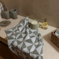 Set of two Italic Umbra bath washcloths in sage and ecru, soft and plush for home bath or shower use.