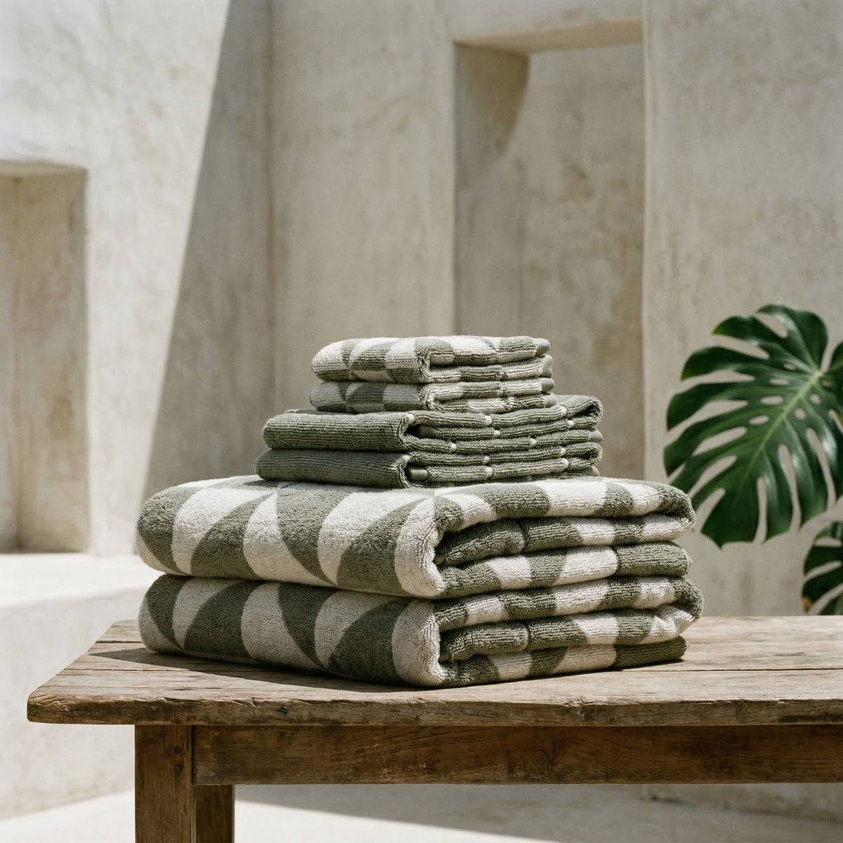 Set of two Italic Umbra bath towels in sage and ecru, soft and plush for home bathroom use.