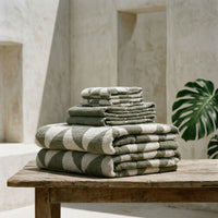 Set of two Italic Umbra bath towels in sage and ecru, soft and plush for home bathroom use.