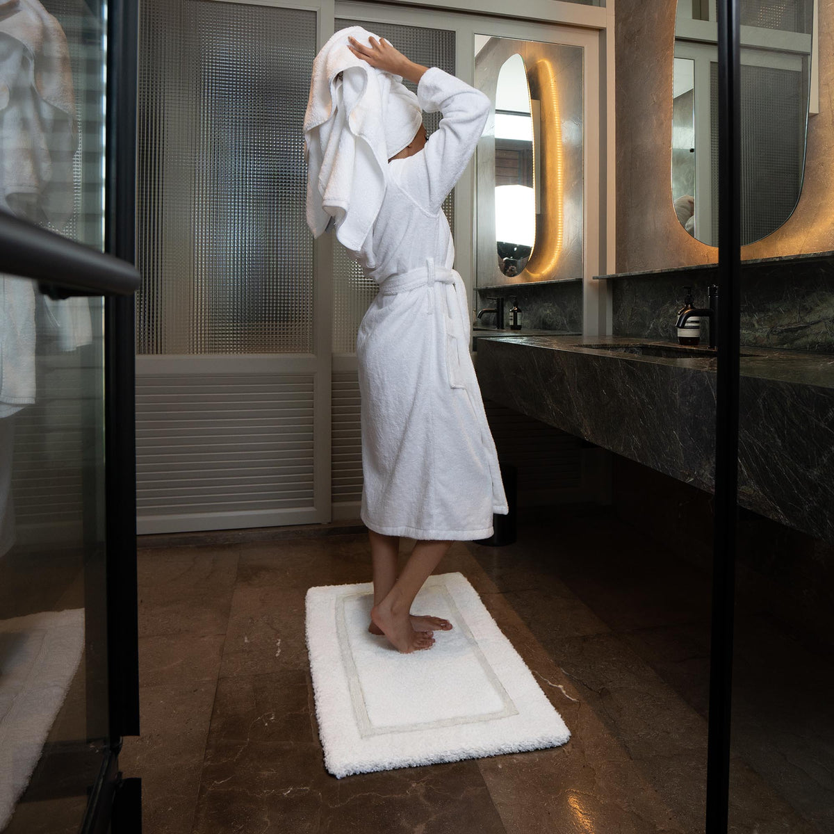 White Italic Ultraplush skid-resistant bath mat with textured surface for safety and comfort in home bathrooms.