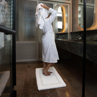 White Italic Ultraplush skid-resistant bath mat with textured surface for safety and comfort in home bathrooms.