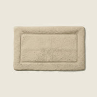 White Italic Ultraplush skid-resistant bath mat with plush texture and non-slip backing for safe, comfortable bathroom use.