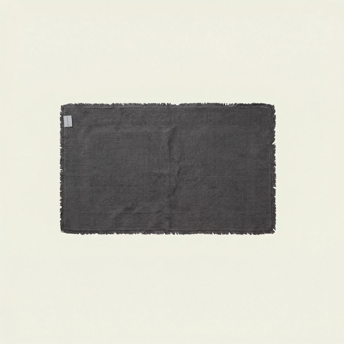 White Italic Ultraplush skid-resistant bath mat with textured surface for added safety in the bathroom.