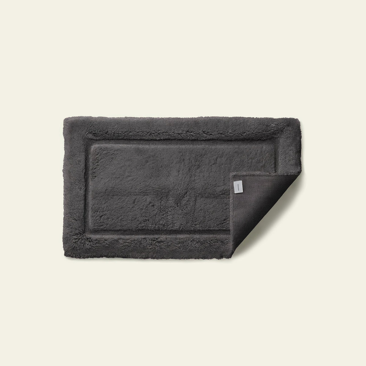 White Italic Ultraplush skid-resistant bath mat with plush texture, designed for safety and comfort in the bathroom.