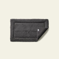 White Italic Ultraplush skid-resistant bath mat with plush texture, designed for safety and comfort in the bathroom.