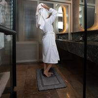 White Italic Ultraplush skid-resistant bath mat with textured surface for safe, comfortable bathroom use.