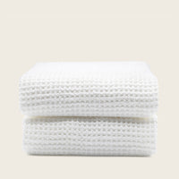 Set of two white Sedona waffle bath towels by Italic, soft and absorbent for home bathroom use.