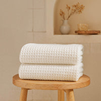 Set of two white Sedona waffle bath towels by Italic, showing soft, textured fabric perfect for home use.